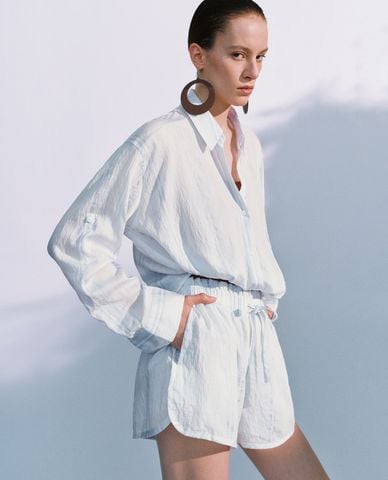  URBAN REVIVO - Áo sơ mi nữ cổ bẻ tay dài xoắn eo 