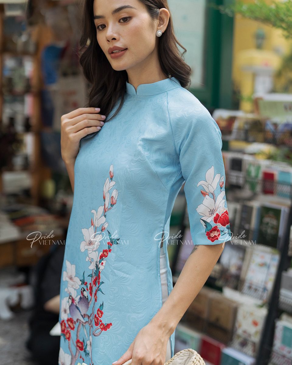 Áo Dài Gấm Xanh Chim Hoa Trắng Bừng Sắc Xuân
