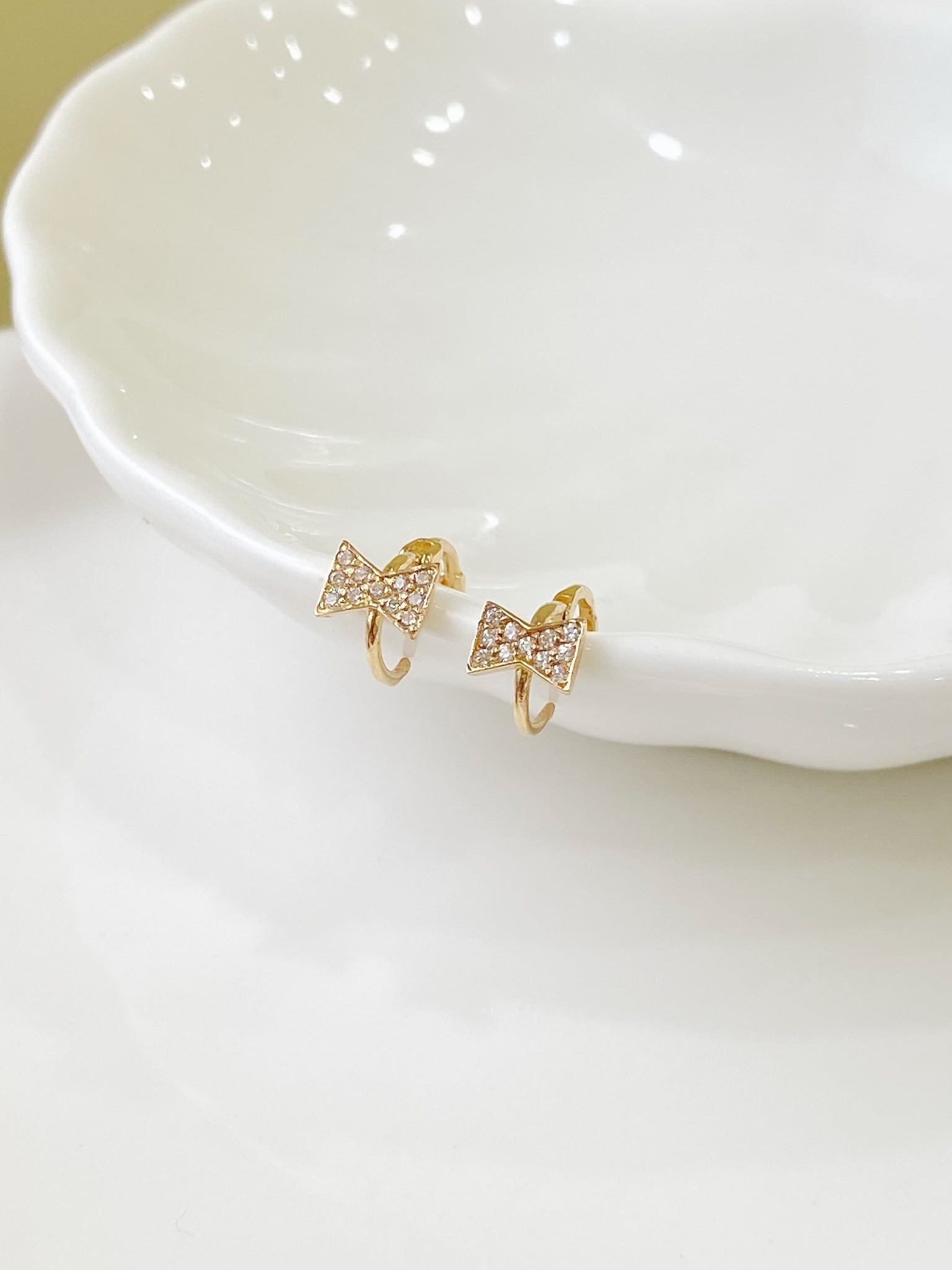  14K Sparkling Bow Mini Huggie 