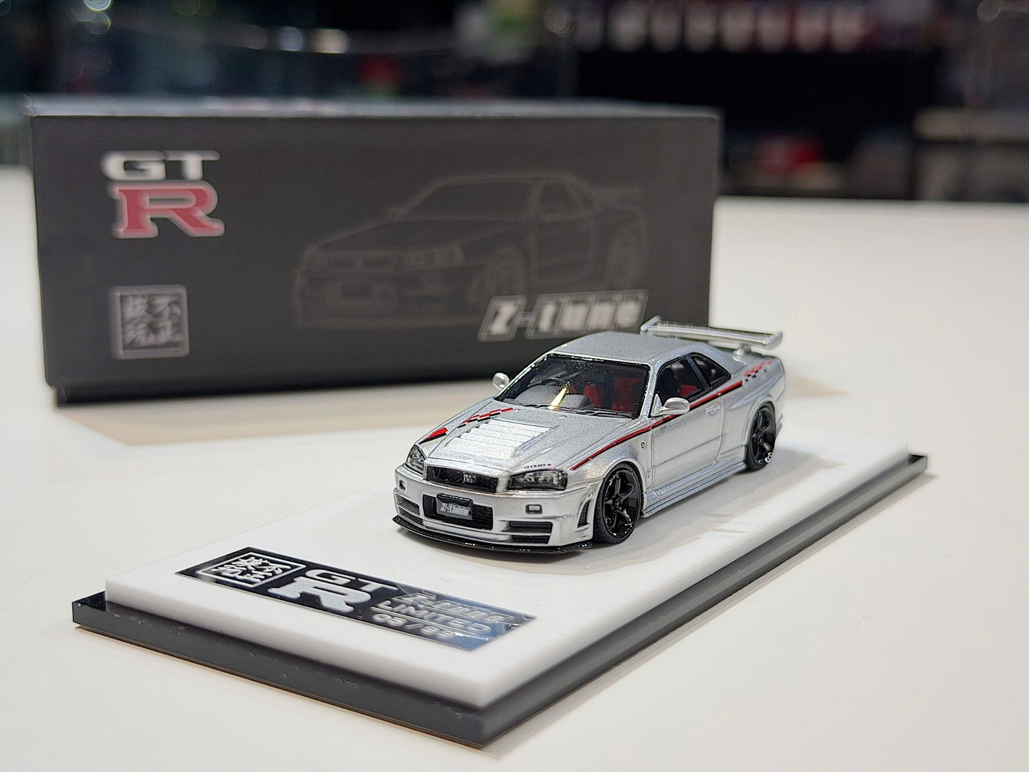XE MÔ HÌNH NISSAN GT-R R34 SKYLINE NISMO Z-TUNE SILVER RED LINE,TỶ LỆ 1/64 SACRILEGIOUS AUTO MODEL