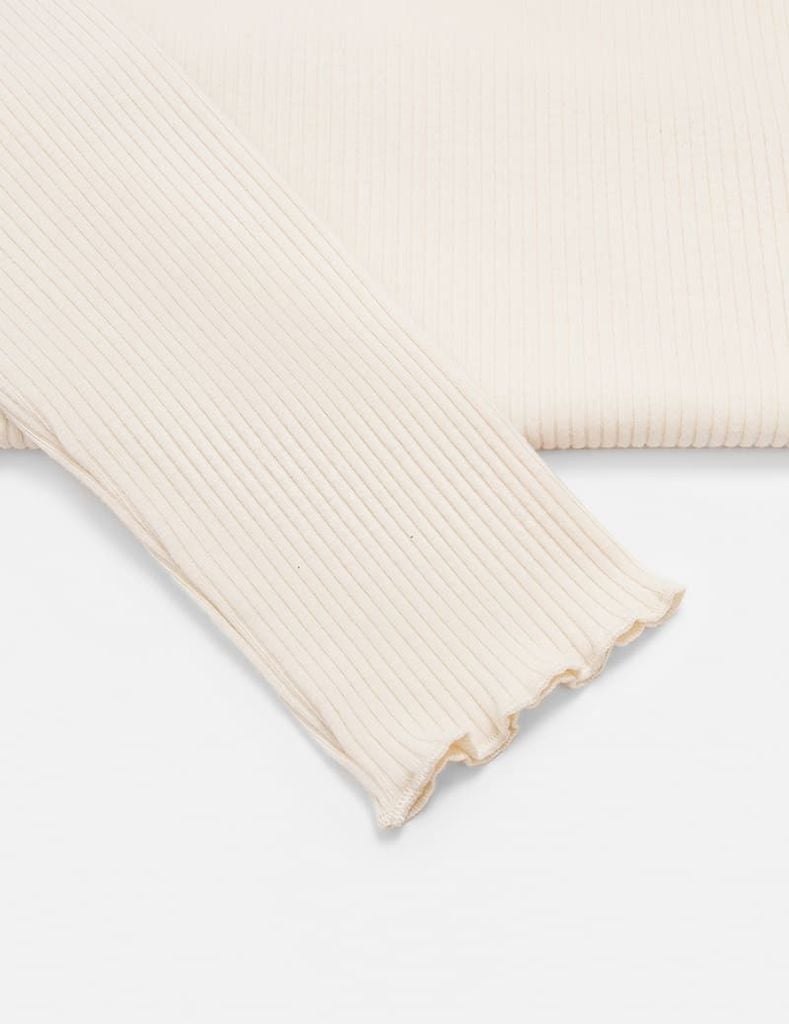 Áo giữ nhiệt cổ cao bé gái hình thêu trước ngực