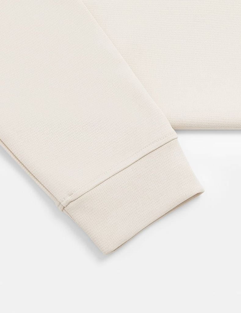 Áo nỉ cổ tròn nữ đính mác dệt trên gấu