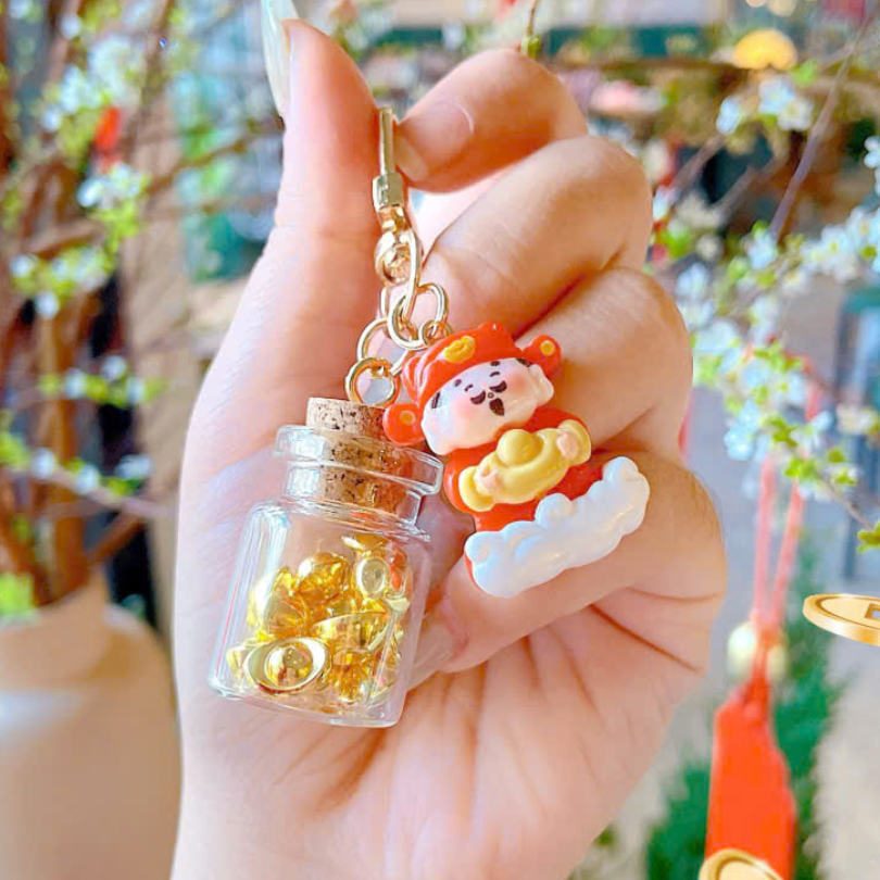 ** Móc khóa thần tài và hủ vàng