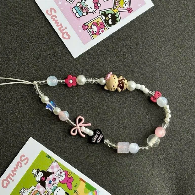 ** Dây đeo điện thoại chuỗi Kitty nơ hồng kèm charm