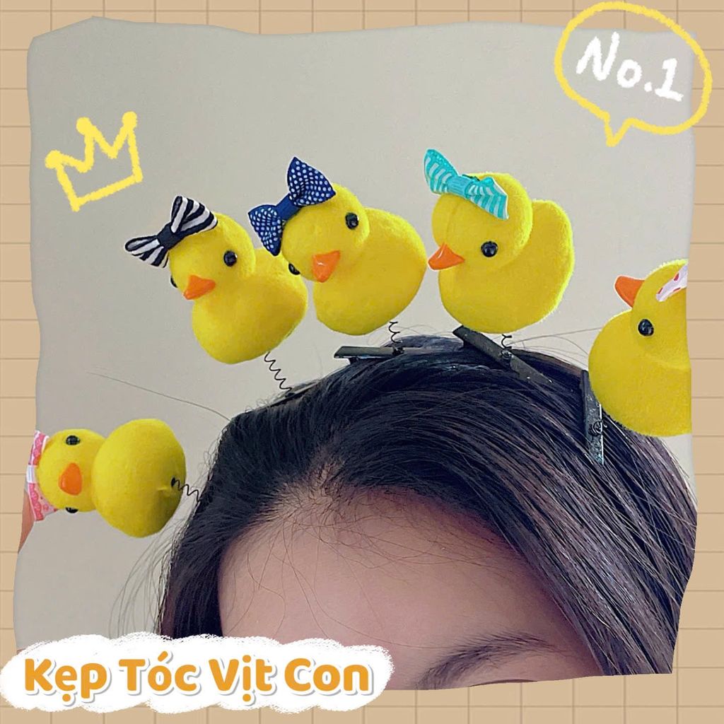 ** Kẹp tóc lò xo vịt vàng đội nơ