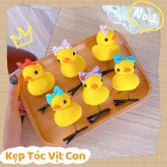 ** Kẹp tóc lò xo vịt vàng đội nơ