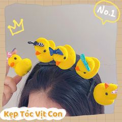 ** Kẹp tóc lò xo vịt vàng đội nơ