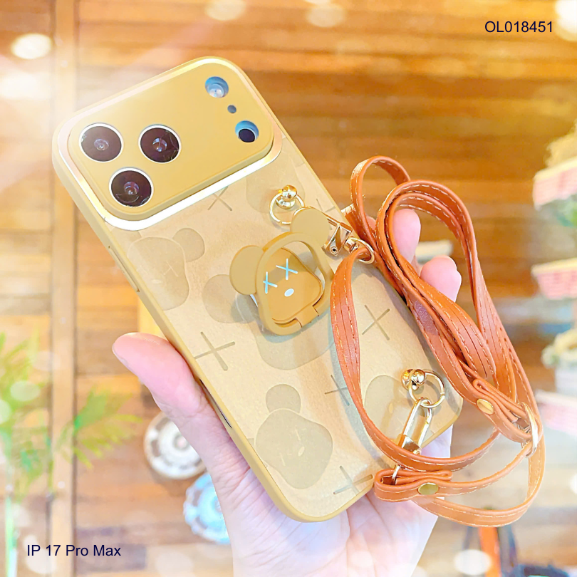 ** Ốp IP 17 Pro Max vân da nâu gấu bearbrick kèm dây đeo