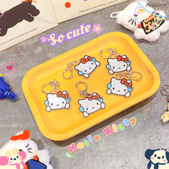 ** Móc khóa mica in Kitty nơ đỏ cầm nĩa xanh