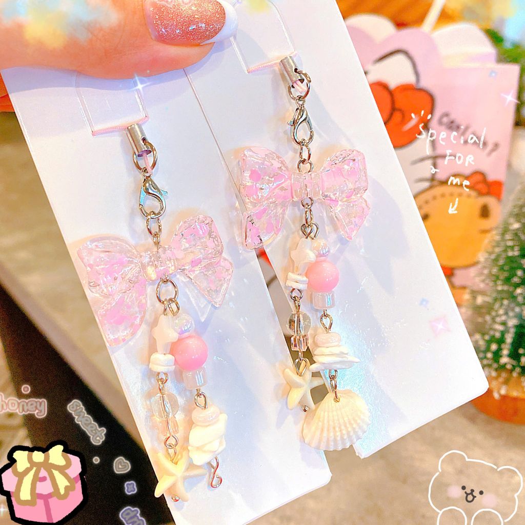 ** Móc khóa nơ hồng vò sò