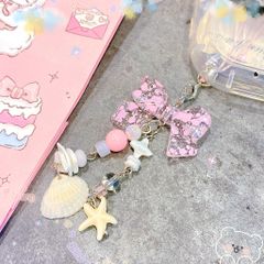 ** Móc khóa nơ hồng vò sò