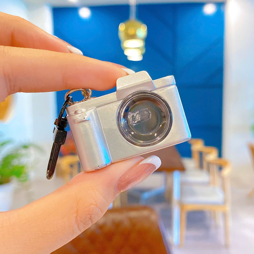 ** Móc khóa súng/máy ảnh bật đèn