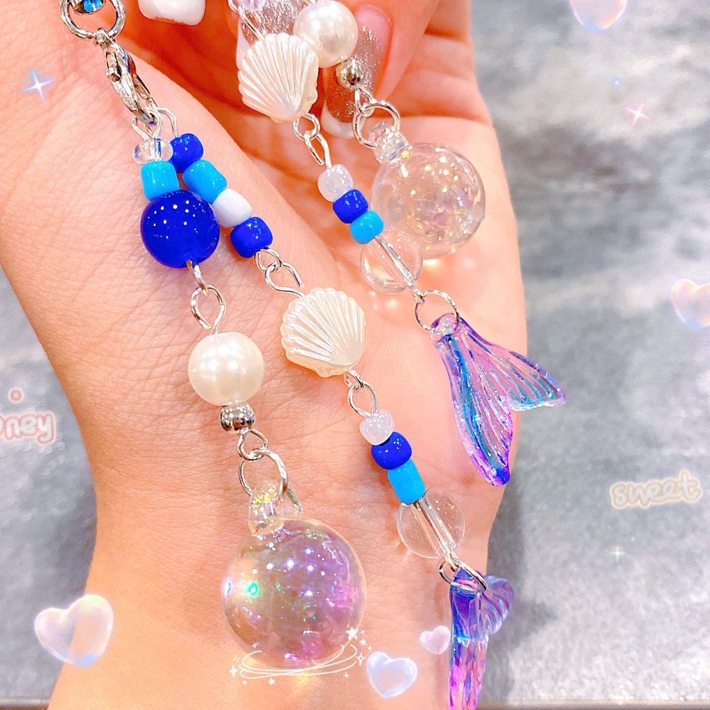 ** Dây đeo điện thoại chuỗi đuôi cá ánh tím