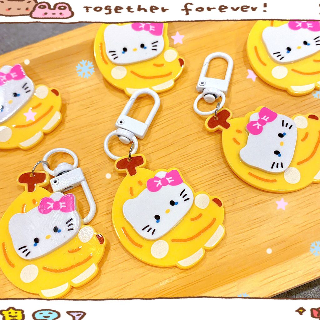 ** Móc khóa chuối đính mặt Kitty