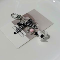 ** Móc khóa bò sữa nơ caro