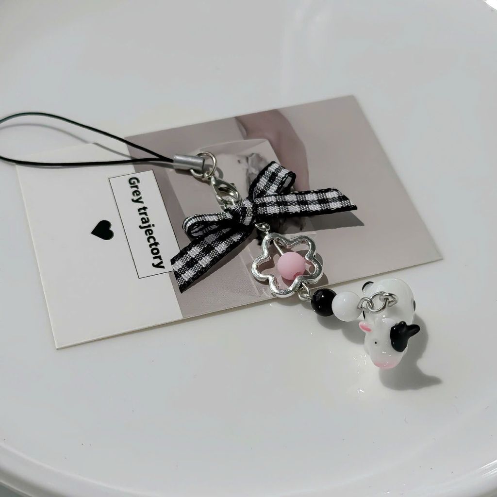 ** Móc khóa bò sữa nơ caro