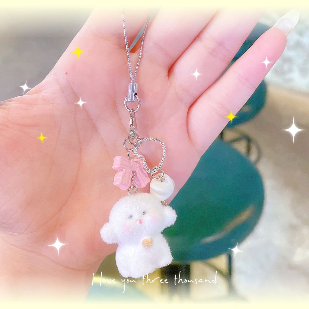 ** Dây đeo điện thoại cún trắng phủ lông nơ hồng