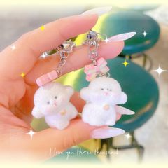 ** Dây đeo điện thoại cún trắng phủ lông nơ hồng