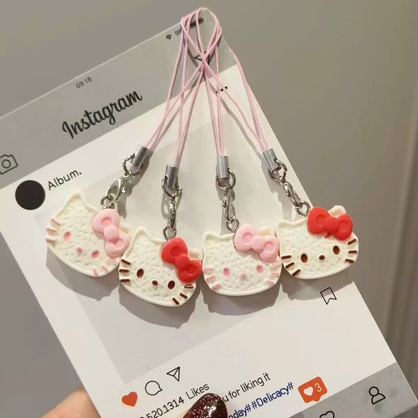 ** Dây đeo điện thoại mặt Kitty nơ hồng/đỏ