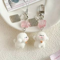 ** Móc khóa cún trắng phủ lông nơ hồng