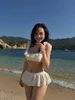 Set bikini áo cổ u viền bèo mix quần giả váy xòe - TRẮNG - G315