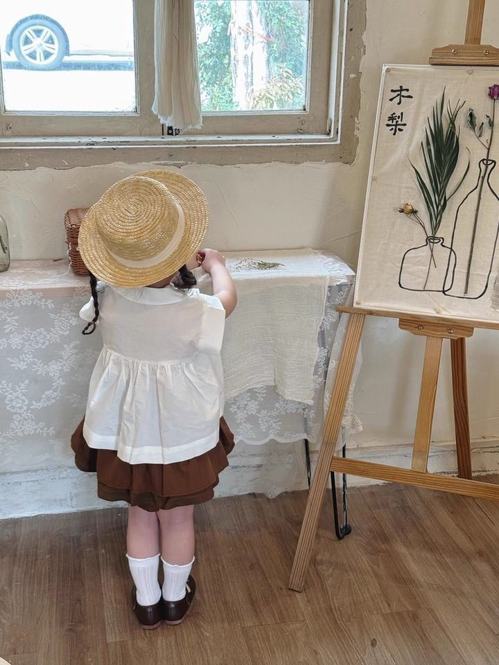 Set Bé Gái Áo Trắng Nhún Ngực Mix Chân Váy Nâu 2 Tầng Có Chip
