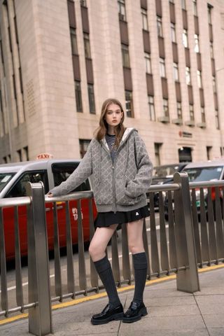  6.Chân váy ngắn xếp ly đen, gấu trắng, cạp chữ chạy 