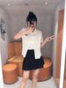  Áo sơ mi trắng logo đen , cổ sen , viền ren 