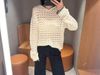  1.Áo len trắng lưới có mũ, viền đen 