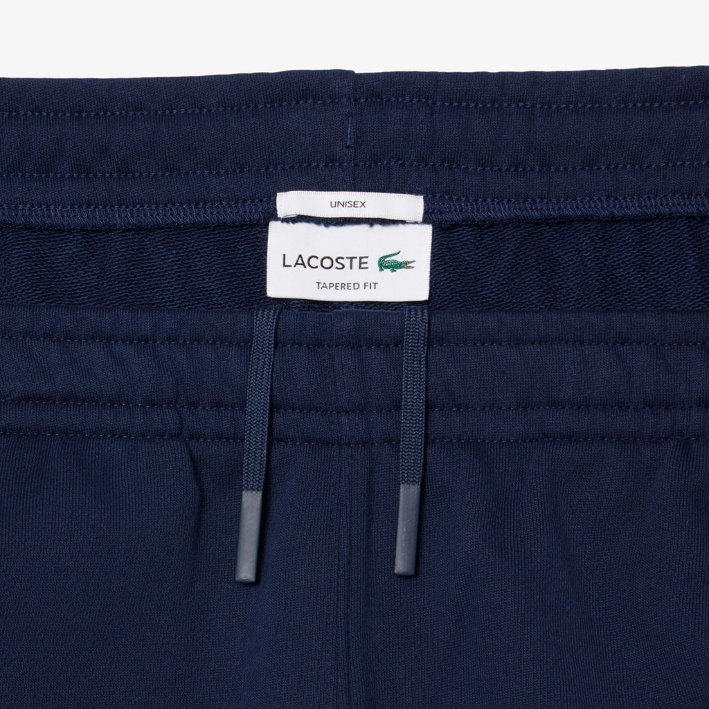 Quần Nỉ Lacoste Unisex Ống Côn Logo Dập Nổi