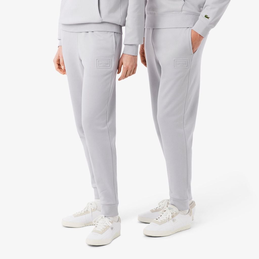 Quần Nỉ Lacoste Unisex Ống Côn Logo Dập Nổi