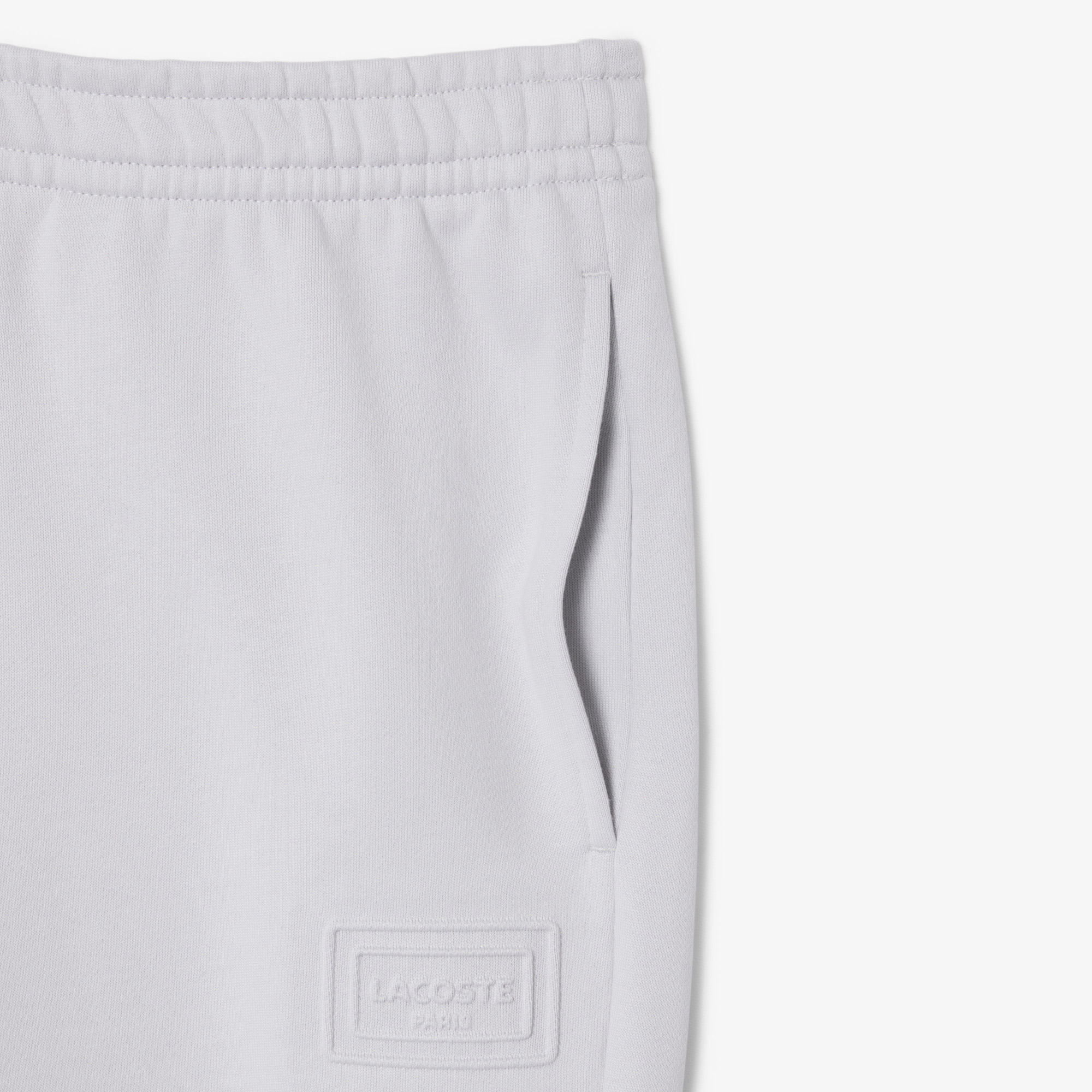 Quần Nỉ Lacoste Unisex Ống Côn Logo Dập Nổi