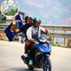 Happy traveler enjoying a Ha Giang Loop motorbike tour with a professional Easy Rider from Hagiangtrips.