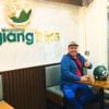 Satisfied customer giving a thumbs up at Hagiangtrips office before starting the adventure.