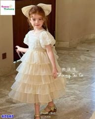 Đầm tiệc kem tầng đính nơ