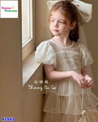 Đầm tiệc kem tầng đính nơ