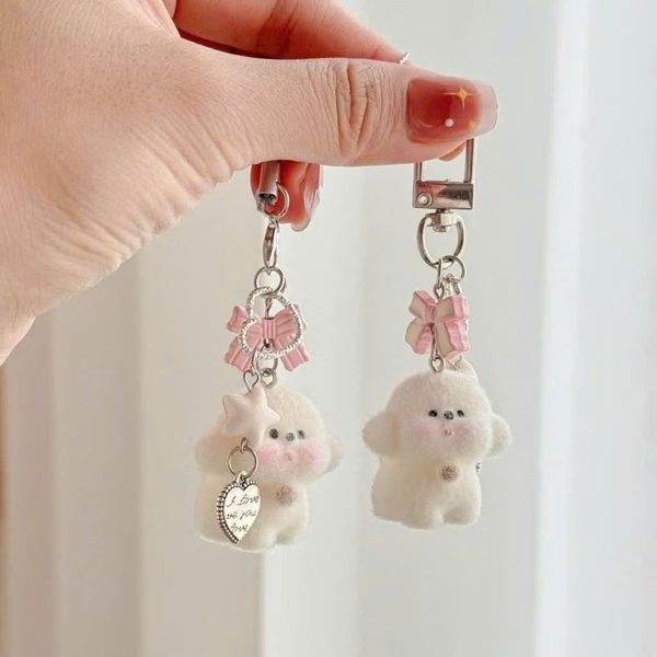 Móc khóa cún trắng nơ phủ lông
