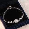 Lắc tay bạc Việt Nam xi vàng trắng mặt tuyết cạnh hoa đá Moissanite | Cáo Bạc