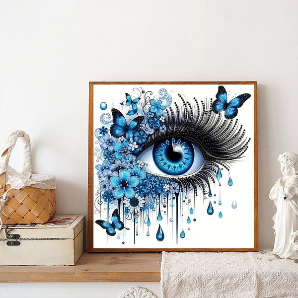 Tranh đính đá nghệ thuật hình đôi mắt xanh – Thiết kế 3D sống động, kèm bướm và hoa xanh, kích thước 30x30cm