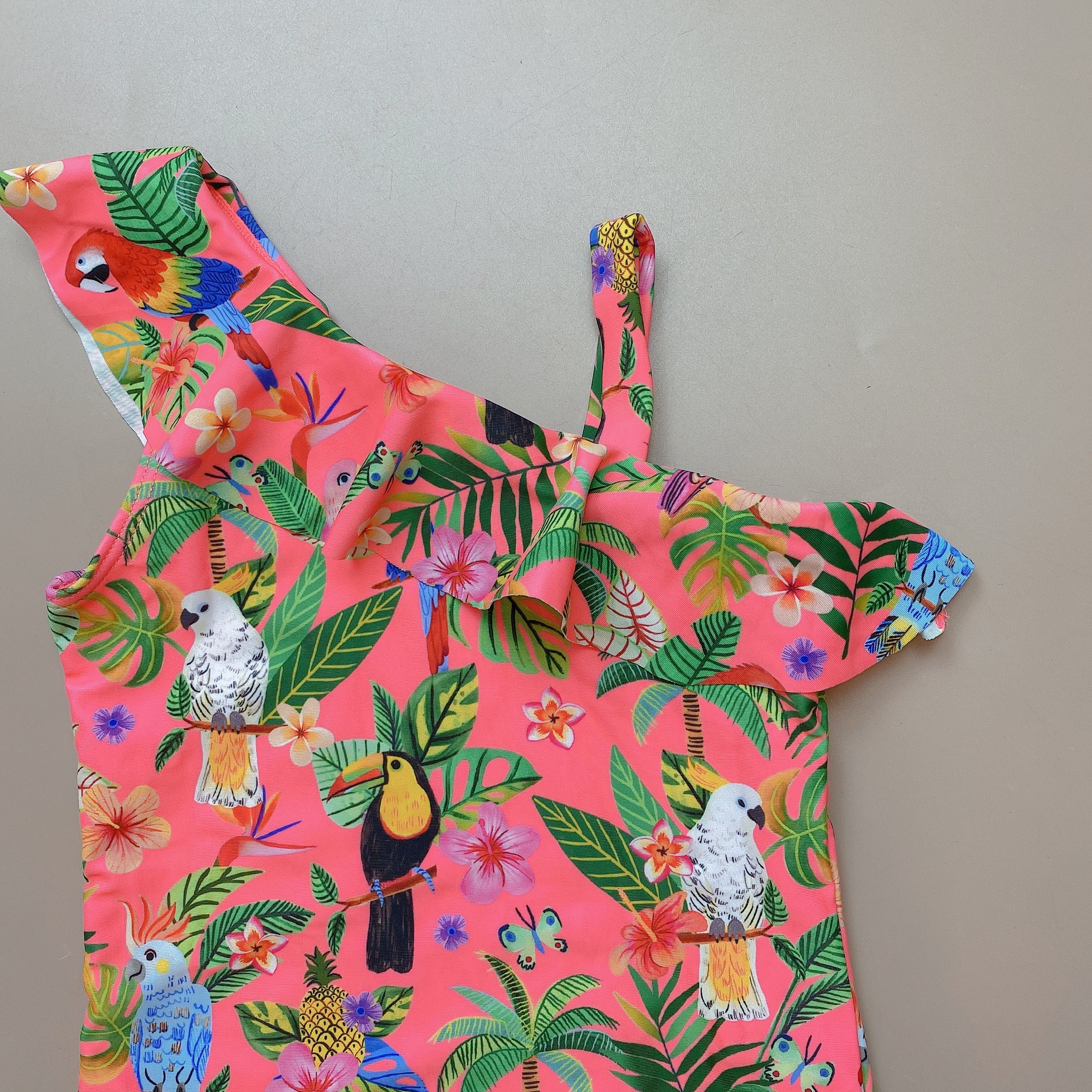 Bộ bơi liền HM màu cam neon hình vẹt vạt bèo lệch size 2 - 10y