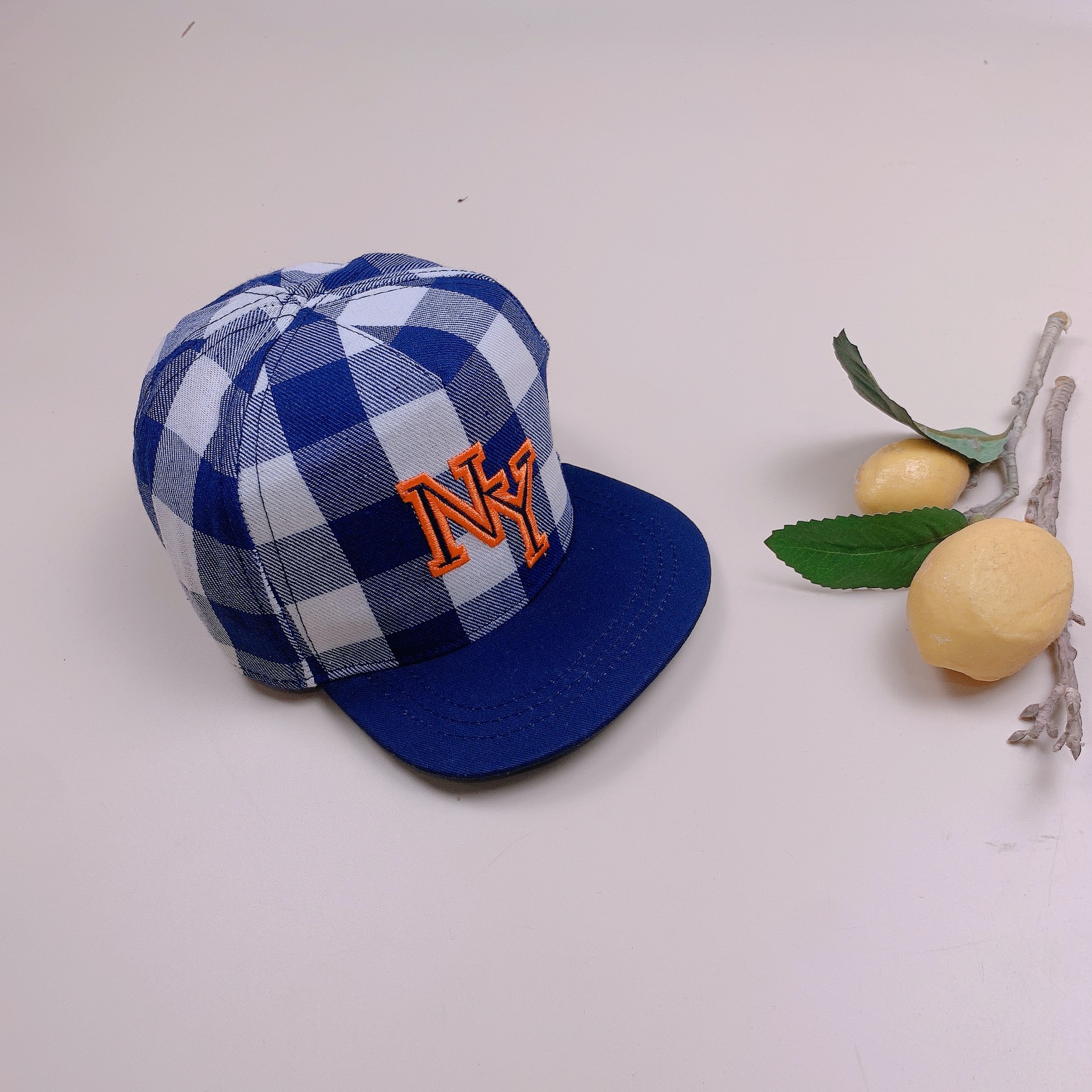Mũ HM màu kẻ caro xanh trắng chữ NY