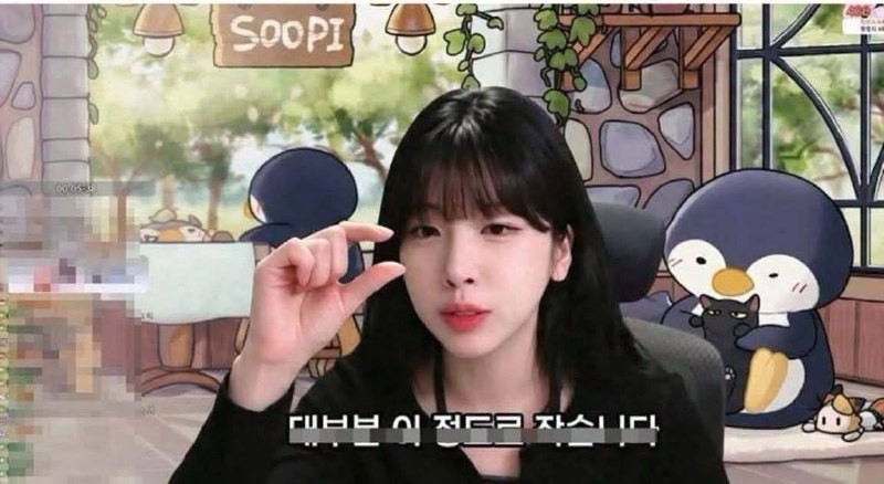Streamer Soopi giơ hai ngón tay khép sát nhau trên sóng livestream, phụ đề tiếng Hàn đa số chỉ nhỏ cỡ này