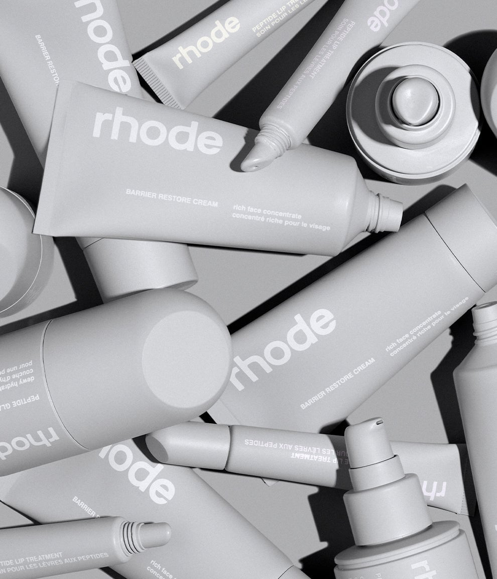 large pile of rhode products, including: peptide glazing fluid, barrier restore cream & peptide lip treament